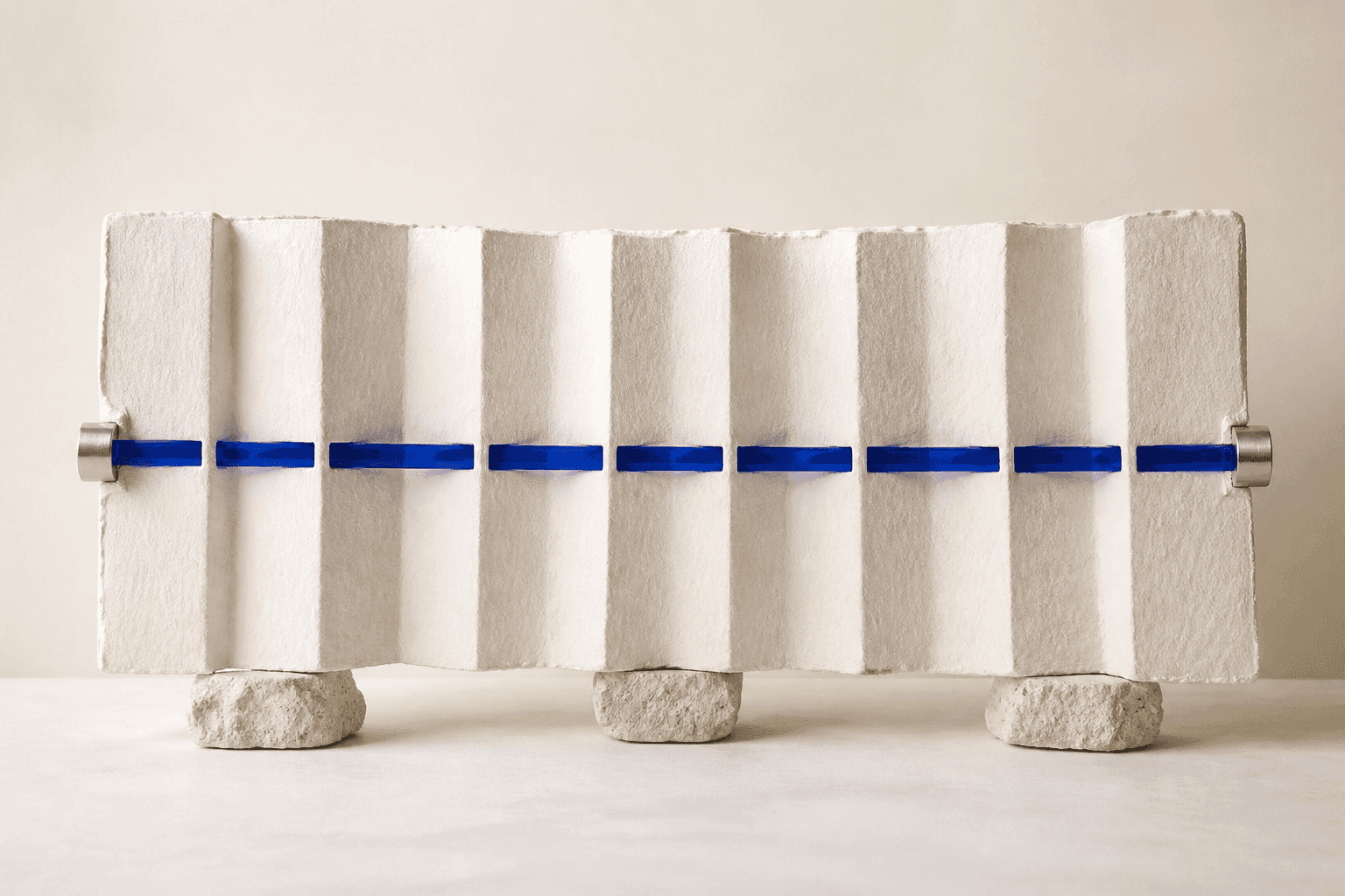 Generated front-facing illustration of a broad pleated ivory paper sheet resting on small stone feet and crossed by one horizontal rail of cobalt glass and brushed aluminium.