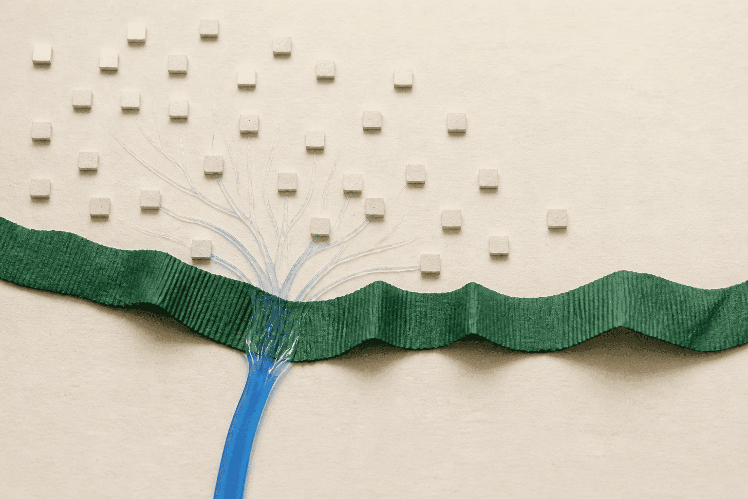 Overhead view of a generated still life where a ribbed forest-green paper strip is crossed by a cobalt resin ribbon that branches towards small ivory tiles.